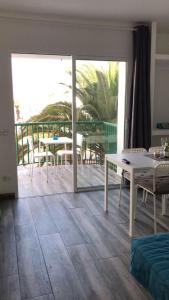 a living room with a patio with a table and chairs at Apartment Enjoy Corralejo in Corralejo