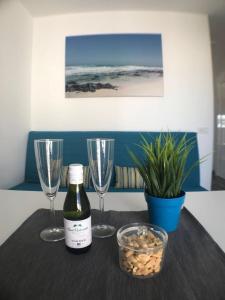 a table with two glasses and a bottle of wine at Apartment Enjoy Corralejo in Corralejo