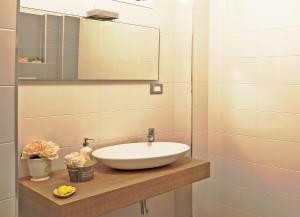 een badkamer met een wastafel en een spiegel bij GiaVa Apartment in Baronissi