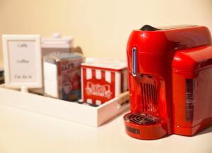 a red mixer sitting on top of a counter at GiaVa Apartment in Baronissi +4 photos