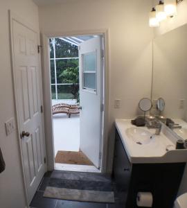 a bathroom with a sink and a door to a yard at Villa Dunes Court in Haines City