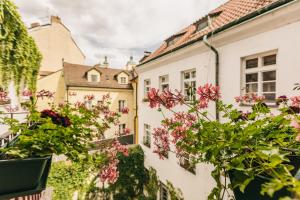 a view of flowers on a balcony of a building at Prague Siesta Apartments in Prague