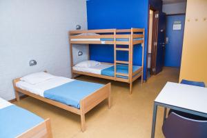 A bed or beds in a room at Hostel Blauwput Leuven