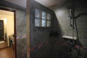 a shower in a bathroom with a window at Palita Lodge - SHA Plus in Haad Rin
