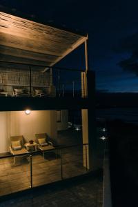 a building with a balcony with a couch and a table at Linhof Boutique Guest House in Paternoster