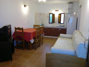 a kitchen with a couch and a table and a kitchen with a refrigerator at Posada Las Dunas in San Bernardo +45 photos