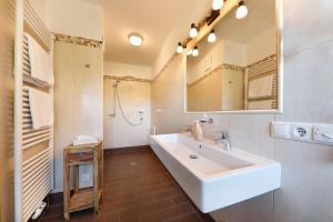 a bathroom with a white sink and a mirror at Steinegger in Appiano sulla Strada del Vino