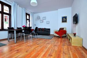 uma sala de estar com uma mesa e um sofá em Best Location Szewska em Toruń