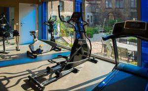 a gym with two exercise bikes in front of a window at Hotel Jan Brito in Bruges