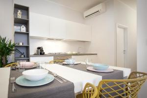 a kitchen with a table with bowls and plates on it at L'Appartamento del Corso in Santarcangelo di Romagna