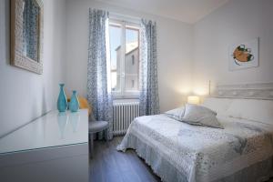A bed or beds in a room at L'Appartamento del Corso