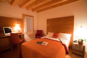 Säng eller sängar i ett rum på Borgo Ronchetto