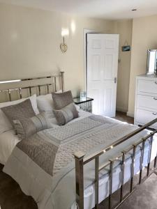 um quarto com uma cama grande e uma porta branca em The Old Dairy em Wakefield