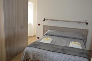 a bedroom with a bed with a gray bedspread at Guest House - Il Granaio in Norma