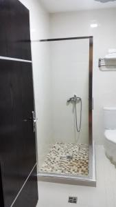 a shower with a glass door in a bathroom at Hotel Alpet in Rinas