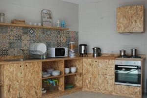 a kitchen with a stove top oven and a microwave at EsposendeGuesthouse in Esposende