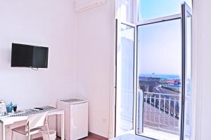 Televízia a/alebo spoločenská miestnosť v ubytovaní I Giardini Del Re