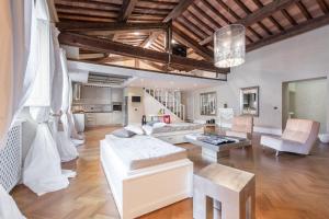 a living room with a white couch and a table at Duomo Luxury Loft in Florence