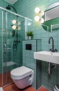 a bathroom with a toilet and a sink and a shower at Stay Swanky Hostel in Zagreb