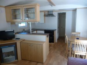 a kitchen with a counter and a table with a dining room at Camping Moraira in Moraira