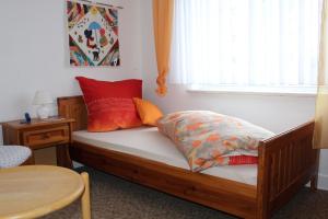 a bedroom with a wooden bed with a window at Ferienhaus Laydeckersch in Mastershausen