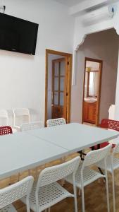 a conference room with a white table and chairs at Ruzafa Apartments in Valencia