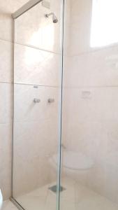 a shower with a glass door in a bathroom at Hotel Premier in Campo Grande +20 photos
