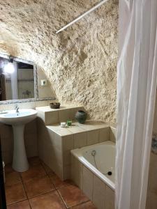 a bathroom with a sink and a bath tub at La Cueva in Vélez Blanco +35 photos