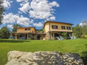 a large house with two lawn chairs in front of it at Agriturismo Tripala in Minucciano