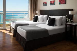 
A bed or beds in a room at Dazzler by Wyndham Puerto Madryn
