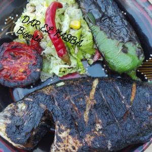 a plate of food with a steak and vegetables at Dar El Kasba Bizerte in Bizerte