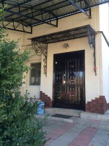 a front door of a house with a black door at Rooms with Fortetsya View in Kamianets-Podilskyi