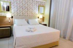 a hotel room with a bed with towels on it at Hotel Ecos Classic in Porto Velho