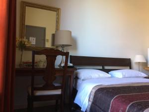 Postel nebo postele na pokoji v ubytování Hotel Bon Accueil