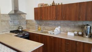 a kitchen with wooden cabinets and a stove top oven at Noclegi Na Wzgórzu in Krajno Pierwsze
