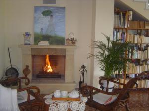 a living room with a fireplace and a table and chairs at Casa Rural La Torreta in Corbera de Alcira
