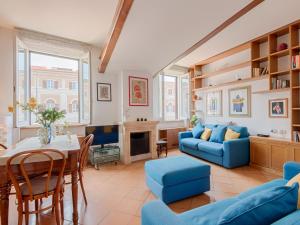 a living room with a blue couch and a table at TREVI Penthouse in Rome