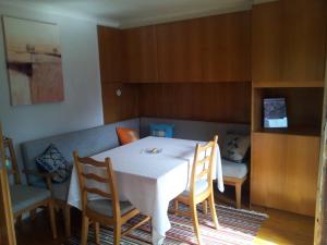 a dining room with a white table and chairs at Fewo Wakolbinger-Wieder in Hallstatt