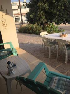 eine Terrasse mit einem Tisch und Stühlen sowie einem Tisch und Stühlen in der Unterkunft Annita Court Block B, Apt6 in Ayia Napa