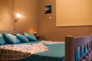 ein Schlafzimmer mit einem Bett mit blauen Kissen in der Unterkunft Annita Court Block B, Apt6 in Ayia Napa
