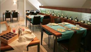 a dining room with tables and chairs in a restaurant at Vinotel Augustin in Sulzfeld am Main