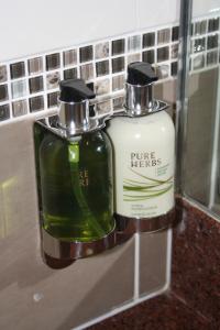 two bottles of soap are sitting on a counter at Madison Plaza Townsville in Townsville