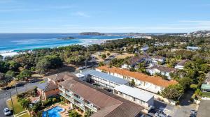an aerial view of a town with the ocean at Surf Beach Motel Coffs in Coffs Harbour