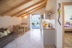 a kitchen and living room with a couch and a table at Grabmayrhof in Termeno