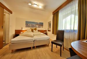 Postel nebo postele na pokoji v ubytování Hotel Garni Fiegl Apart