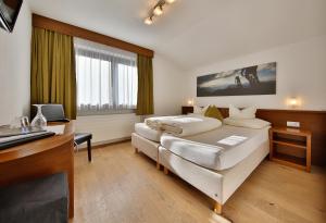 Postel nebo postele na pokoji v ubytování Hotel Garni Fiegl Apart