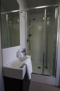 a bathroom with a sink and a shower at 34 Mackenzie Apartments in Twizel