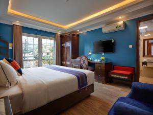 a hotel room with a bed and a television at Eden Boutique Hotel & Spa in Sapa +43 photos