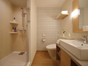 a bathroom with a sink and a toilet and a shower at Red Roof Inn & Suites Osaka Namba Nipponbashi in Osaka