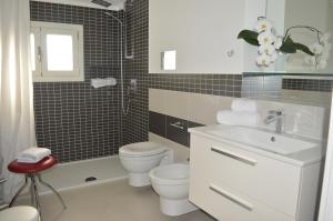 a bathroom with a sink and a toilet and a shower at Casa Ferreri in Santa Ninfa +11 photos